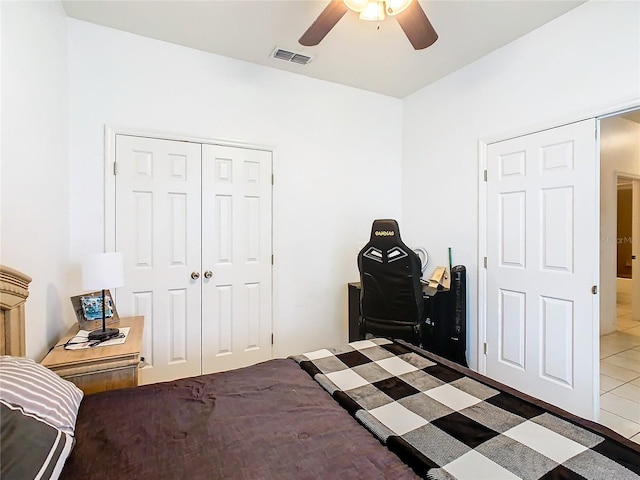 tiled bedroom with a closet and ceiling fan