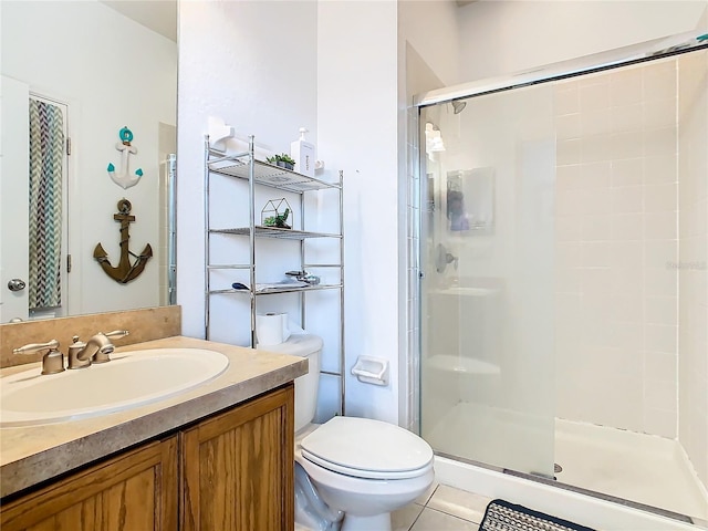 bathroom featuring an enclosed shower, vanity, tile patterned floors, and toilet