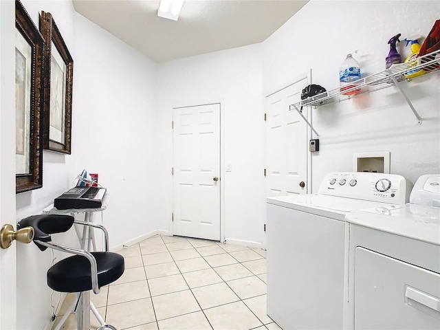 laundry area featuring light tile patterned floors and independent washer and dryer