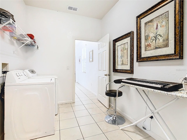 laundry room with light tile patterned flooring and independent washer and dryer