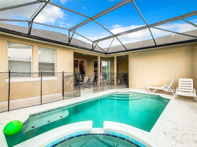 view of pool featuring a patio area and glass enclosure