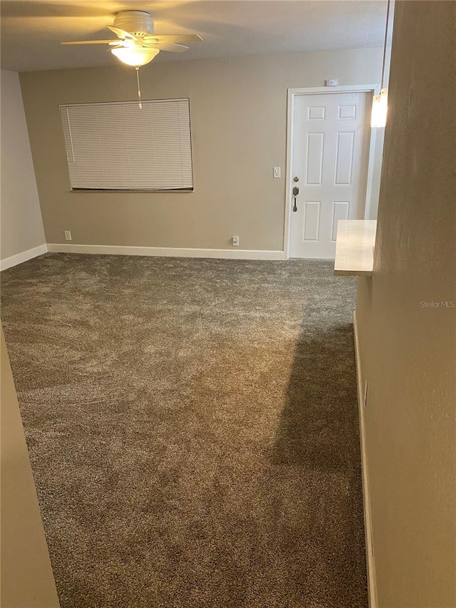 empty room featuring ceiling fan and carpet floors