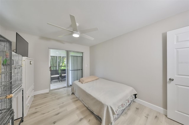 bedroom featuring access to exterior, light hardwood / wood-style floors, and ceiling fan