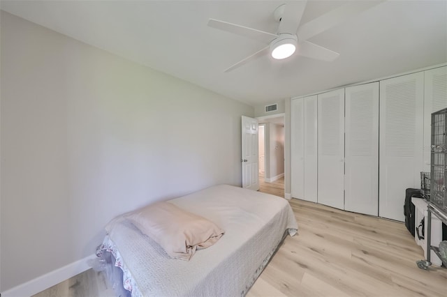 bedroom with ceiling fan, a closet, and light wood-type flooring