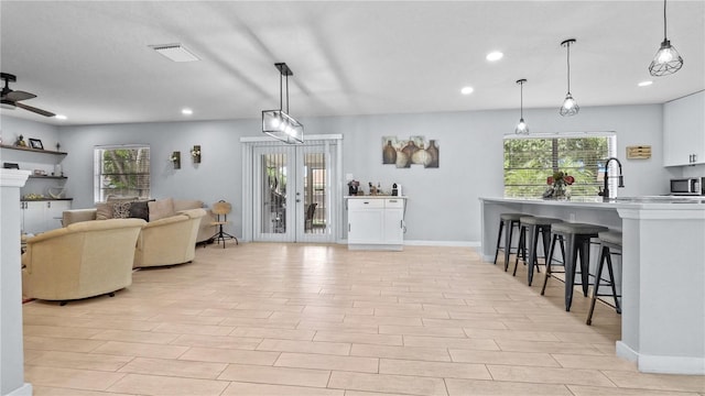 living room with ceiling fan and light wood-type flooring