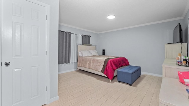 bedroom featuring crown molding and light hardwood / wood-style flooring