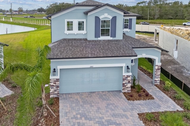 view of front of home with a front lawn and a garage