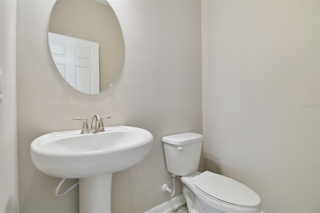 bathroom featuring toilet and sink