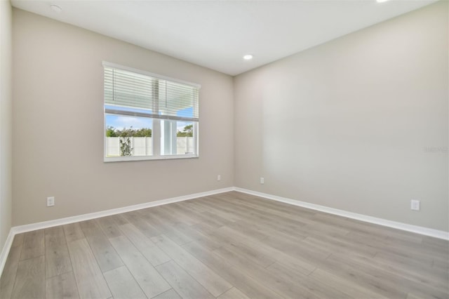 spare room with light hardwood / wood-style flooring