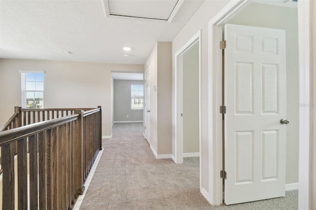 corridor featuring light colored carpet