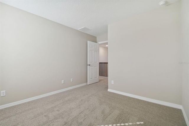 unfurnished room with light carpet