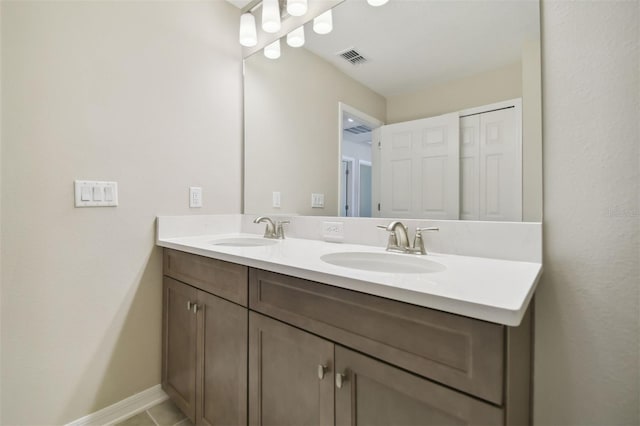 bathroom with tile patterned floors and vanity