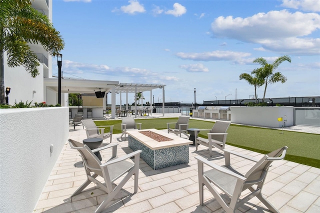 view of patio / terrace featuring a bar and a fire pit