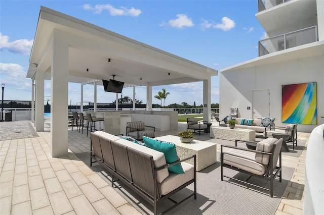 view of patio with a bar and an outdoor hangout area