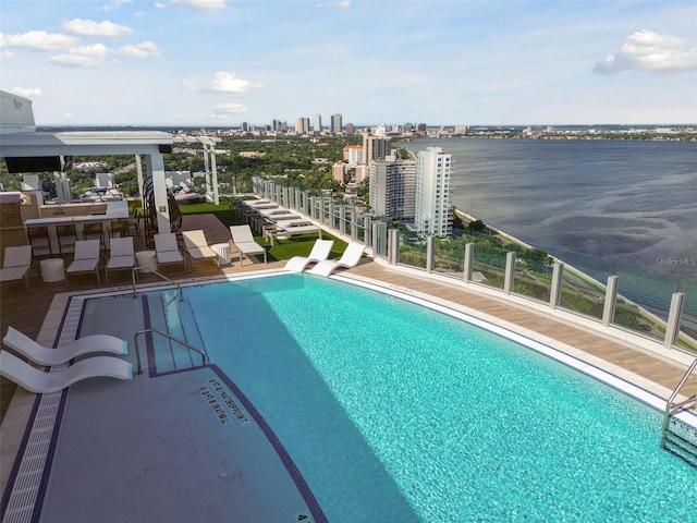 view of pool featuring a water view