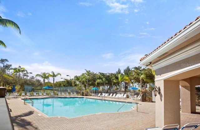 pool featuring a patio area and fence