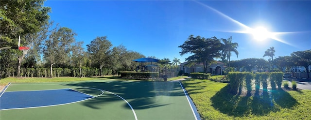 view of basketball court with community basketball court and a lawn