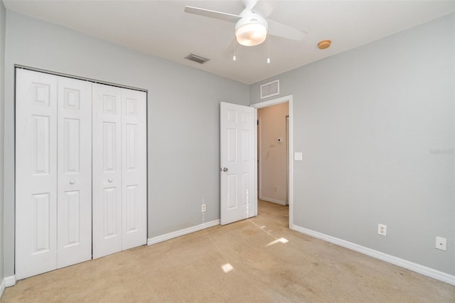 unfurnished bedroom featuring carpet, visible vents, and a closet