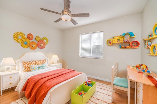 bedroom with ceiling fan, baseboards, and wood finished floors