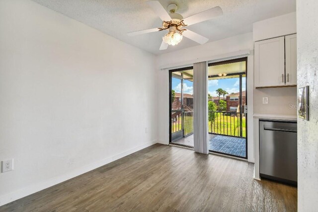 interior space featuring ceiling fan, dark hardwood / wood-style flooring, and a textured ceiling