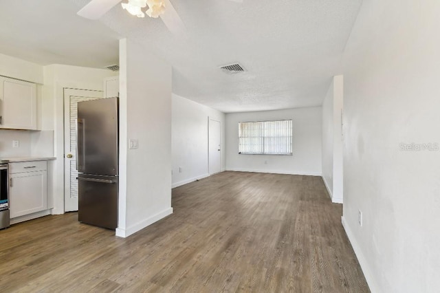 unfurnished living room with hardwood / wood-style floors and ceiling fan