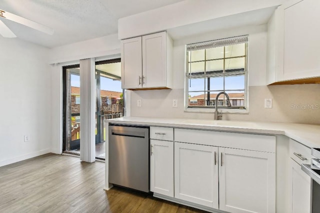 kitchen with white cabinets, wood-type flooring, ceiling fan, sink, and dishwashing machine