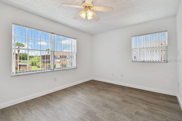 unfurnished room featuring ceiling fan, dark hardwood / wood-style flooring, and a textured ceiling