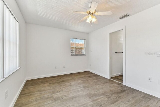 spare room with ceiling fan and wood-type flooring