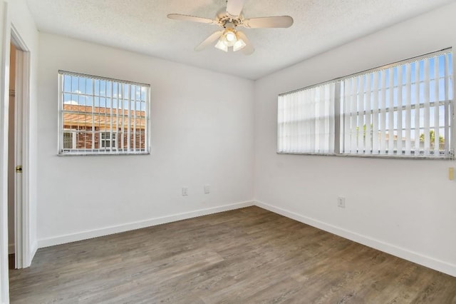 empty room featuring a textured ceiling, hardwood / wood-style floors, and ceiling fan