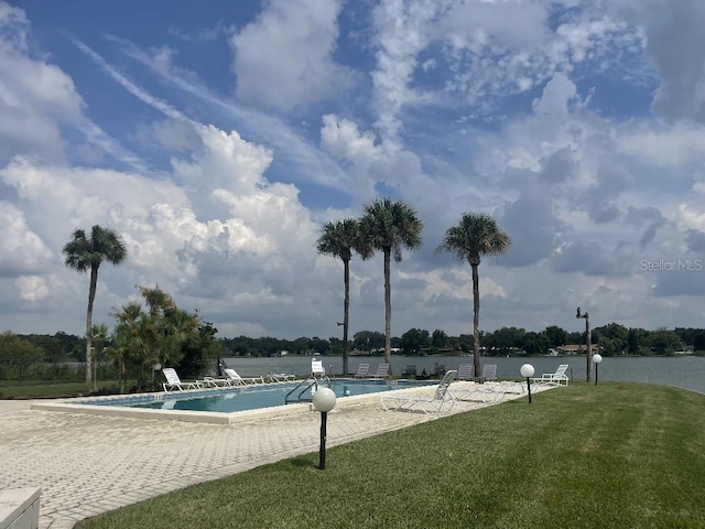 view of pool featuring a lawn