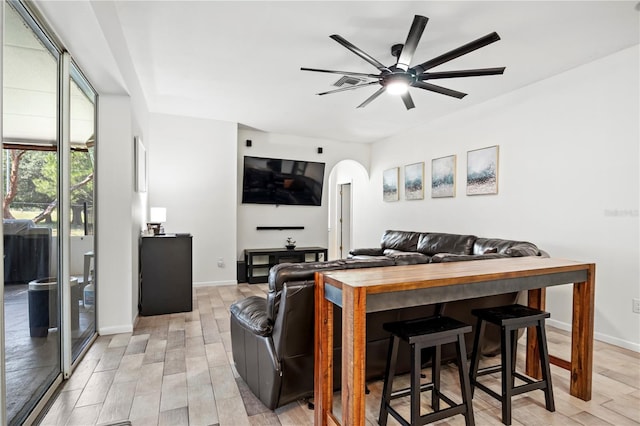 living room featuring light hardwood / wood-style flooring and ceiling fan