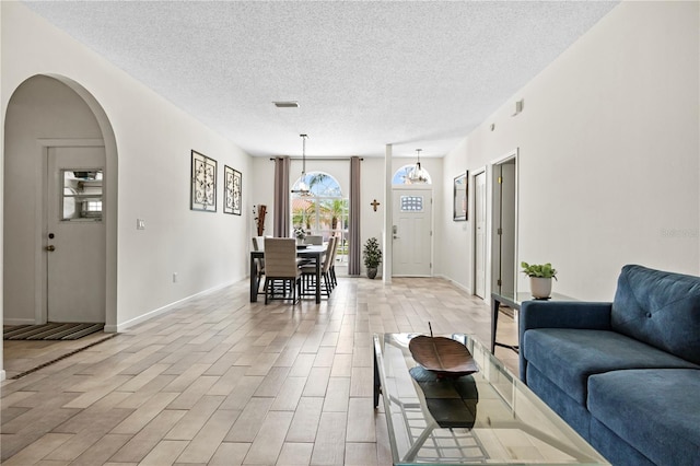 living room with light tile patterned flooring and a textured ceiling