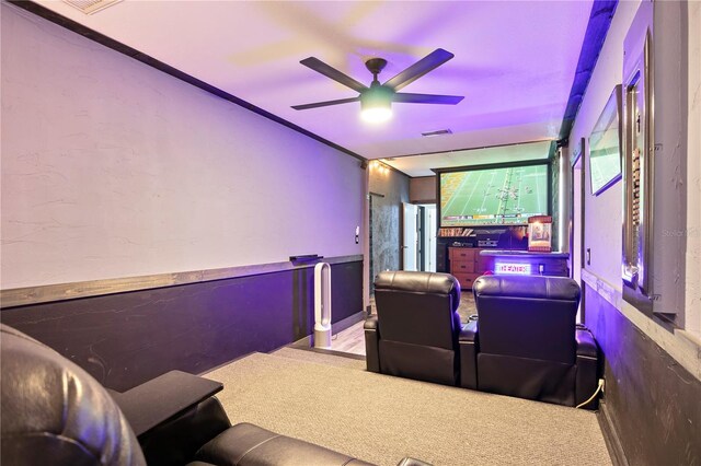 cinema room featuring ceiling fan and carpet floors