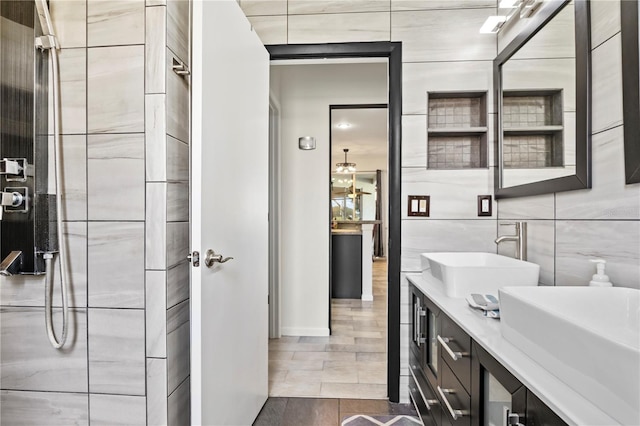 bathroom featuring dual vanity, tile walls, and tile patterned flooring