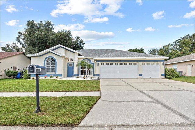 ranch-style home featuring a garage and a front lawn