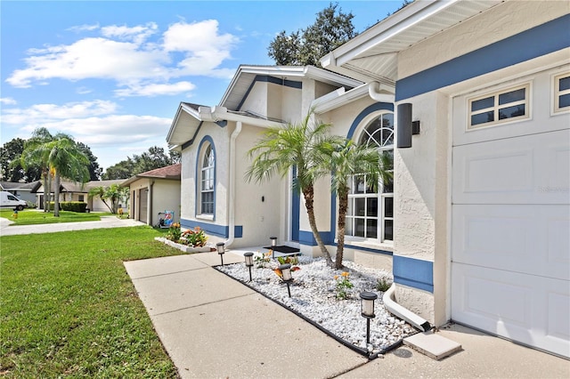 property entrance with a yard and a garage