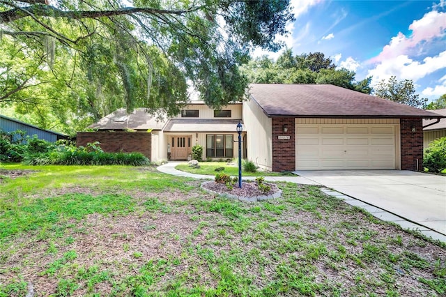 view of front of house with a front yard and a garage