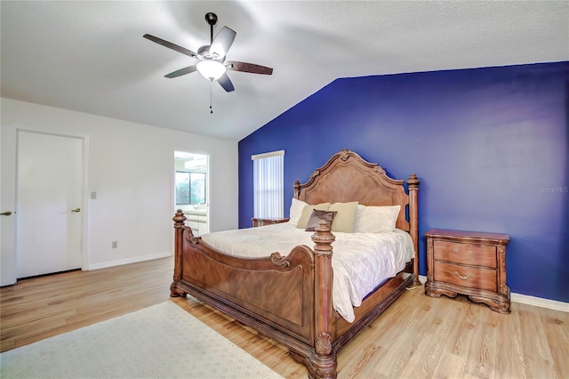 bedroom with light hardwood / wood-style floors, lofted ceiling, and ceiling fan