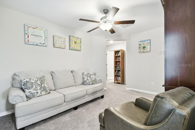 living room featuring ceiling fan and carpet