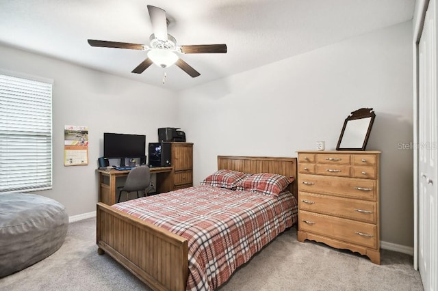 carpeted bedroom featuring a closet and ceiling fan