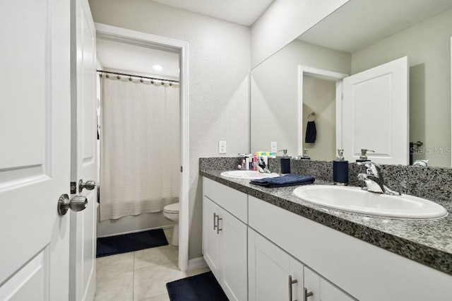 bathroom featuring vanity, tile patterned floors, and toilet