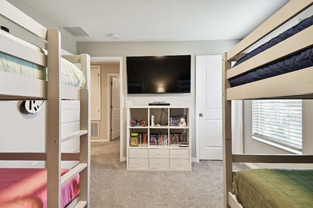 bedroom featuring light colored carpet