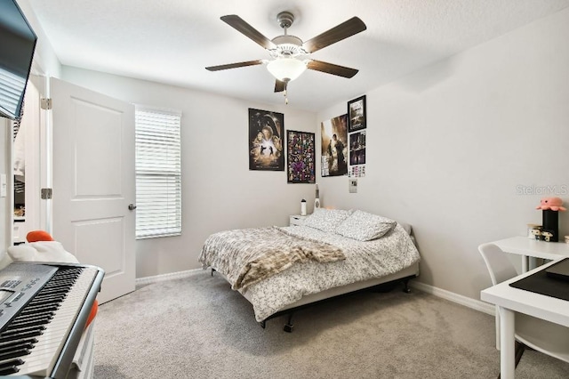 bedroom with ceiling fan and light colored carpet