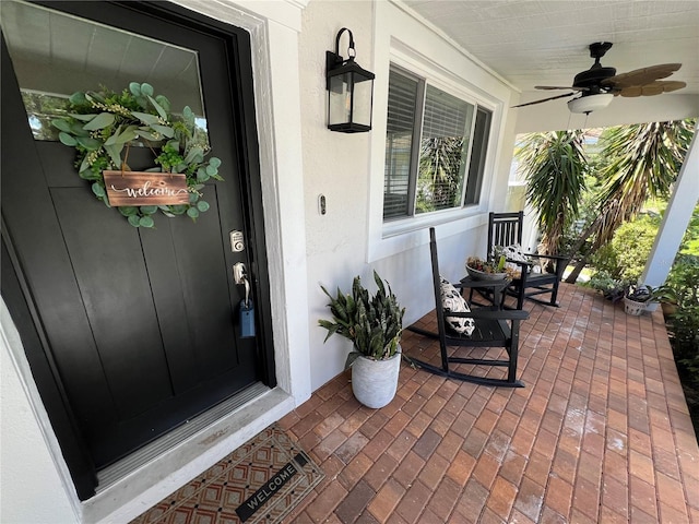 property entrance with ceiling fan and a porch