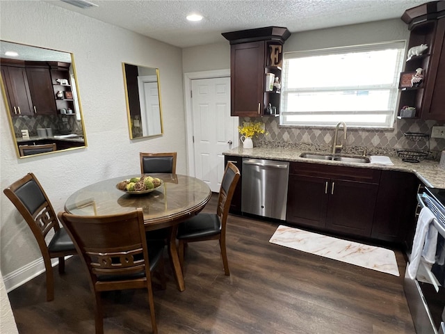 kitchen featuring dishwasher, light stone counters, stove, and sink