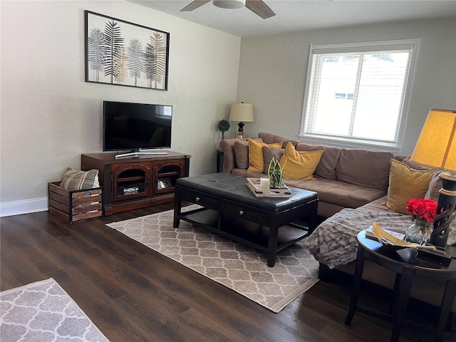 living room with ceiling fan, dark wood-type flooring, and a textured ceiling