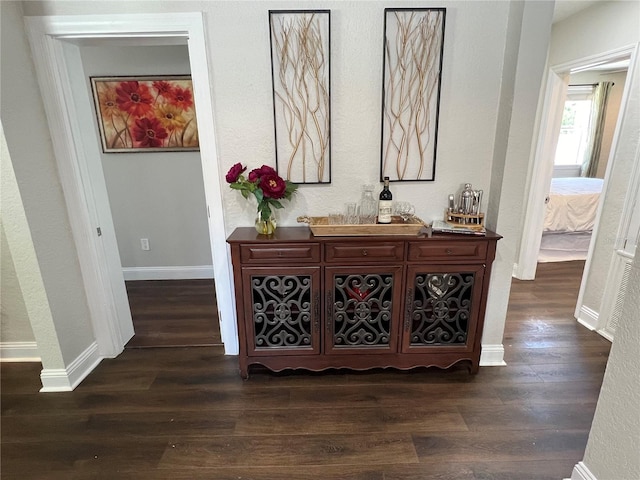 hallway featuring dark hardwood / wood-style flooring