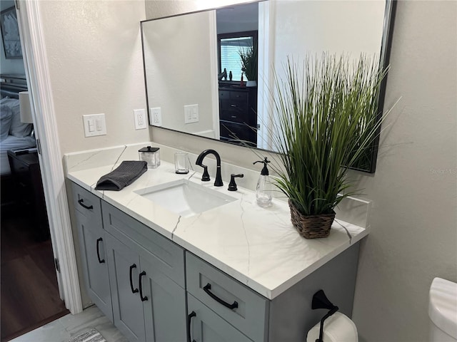 bathroom featuring vanity and toilet