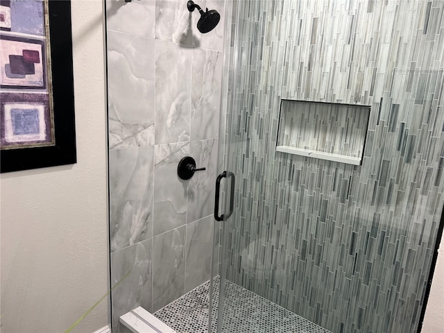 bathroom with a shower with door