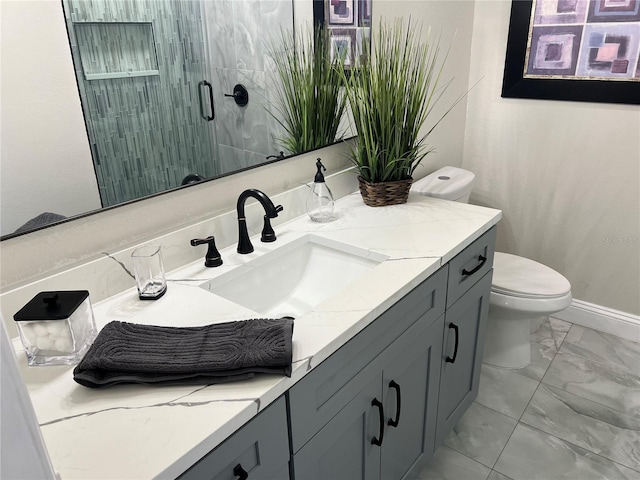 bathroom featuring vanity, toilet, and a shower with door